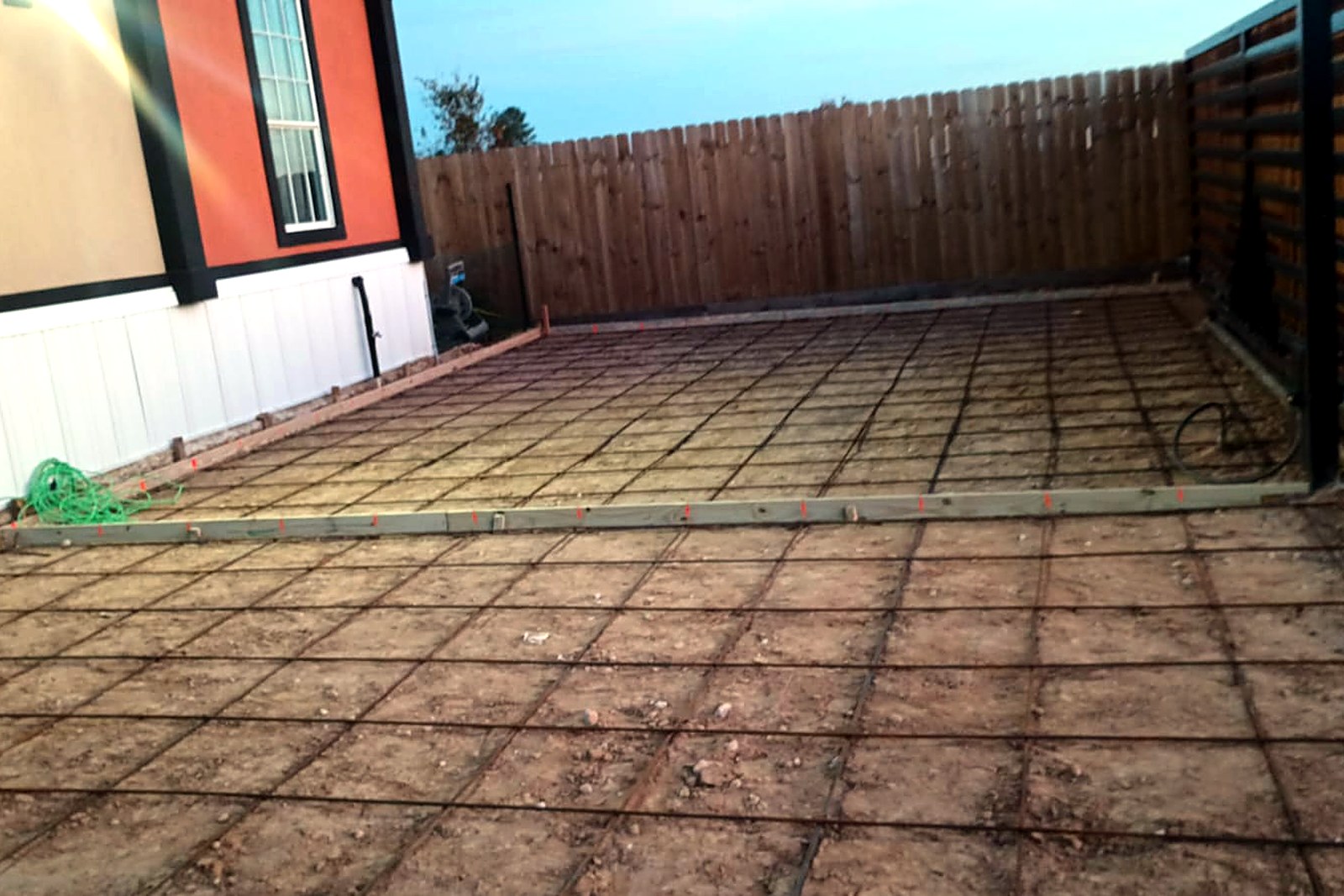 Large rebar grid laid out for an RV pad at dusk