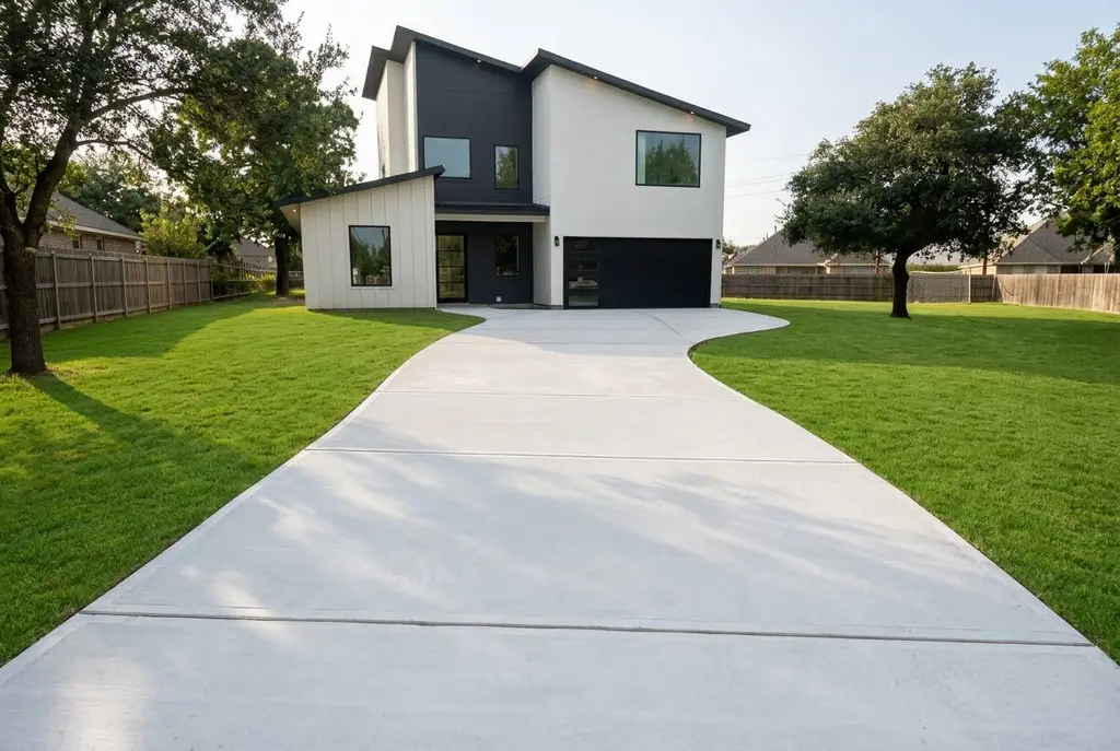 The same Cypress home after a wide broom-finished concrete driveway was poured